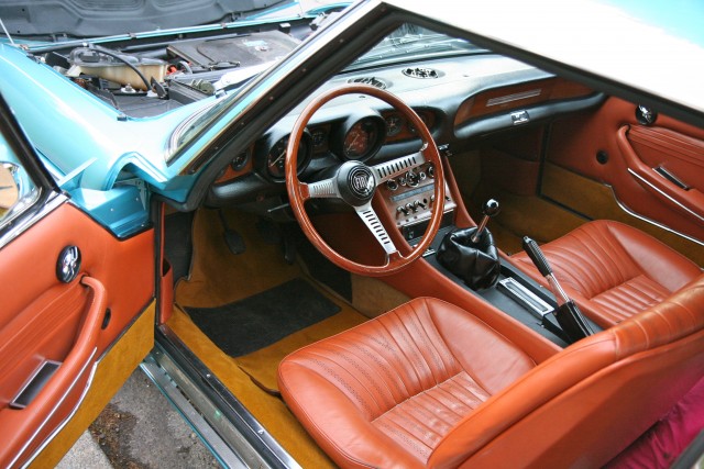 Original leather, all caramel coloured bits are leather. Front seats door cards and transmision tunnel.